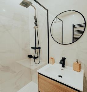 a bathroom with a shower with a sink and a mirror at OH MY HOME BILBAO in Bilbao +40 photos