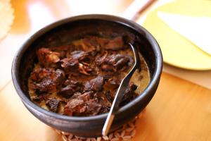 una olla de comida en una mesa con una cuchara en Casinha do Canto en Góis