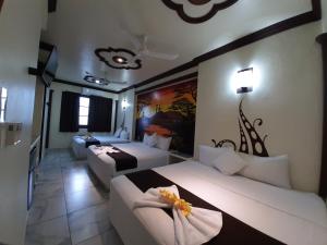 a hotel room with two beds and a couch at Hotel Diamante in Santa Cruz Huatulco