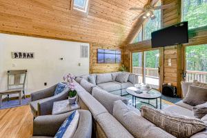 a living room with couches and a flat screen tv at Patel's Cozy Cabin in Glenora