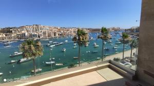 a view of a harbor with boats in the water at Aquamarine Sea Front Apartments - Third Floor in Marsaskala