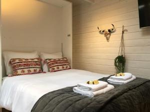 a bedroom with a bed with towels and a cow skull on the wall at Zandvoortferienwohnungen in Zandvoort