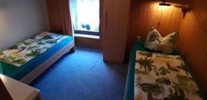 a small room with two beds and a window at Holiday Home Uckeritz - Seebad 1 in Ueckeritz