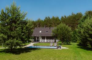 a house with a swimming pool in a yard at Domek Nalesie in Dudowizna