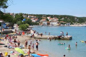 a group of people on a beach in the water at Apartment in Silo/Insel Krk 13562 in Šilo