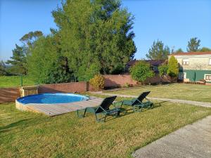 two chairs and a swimming pool in a yard at CASA SEGADE in A Coruña