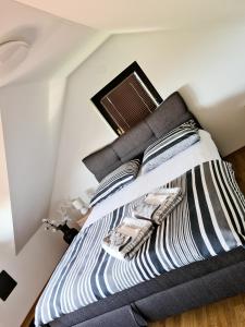 a bedroom with a bed with black and white pillows at Small Hill Heaven in Varaždin Breg +33 photos