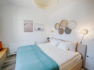 a bedroom with a bed and two mirrors on the wall at Malom és Kacsa in Tata