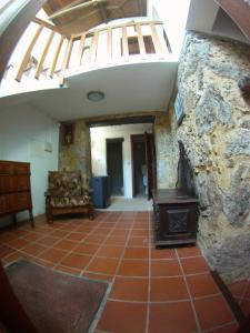 a living room with a stone wall and a stove at Casa de Guadalupe in Redouça +22 photos
