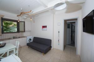 a living room with a couch and a table at Casa Dina in Lefkada Town