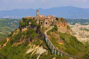un castillo en la cima de una montaña con un tren en Holiday home in Tuscania VT/Latium 22377, en Tuscania