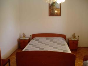 a bedroom with a bed and two night stands at Two-Bedroom Apartment in Senj I in Nehaj
