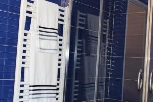 a bathroom with two towels hanging on a shower at Havre de paix au coeur de Cannes in Cannes