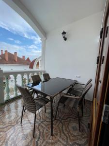 patio con mesa y sillas en el balcón en Гостевой дом Лев, en Eupatoria