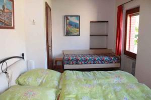 ラツィーゼにあるHoliday home in Lazise/Gardasee 21993のベッドルーム1室(ベッド2台、窓、ベッド1台付)
