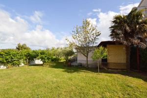 a yard with a house and a tree and grass at Holiday home in Pula/Istrien 17365 in Štinjan