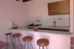 a kitchen with a counter with stools in it at Apartments in Silo/Insel Krk 14530 in Šilo