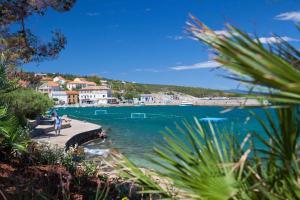 a view of a body of water with people on a dock at Apartment in Silo - Insel Krk 14603 in Šilo