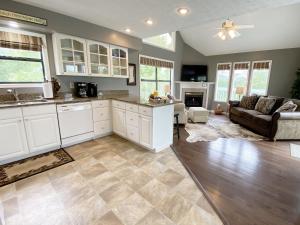 uma cozinha com armários brancos e uma sala de estar em Amazing Sunsets home em Pigeon Forge
