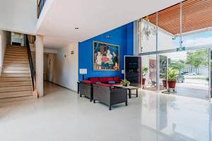 a living room with a red couch and a blue wall at Hotel Siglo 21 Merida in Mérida