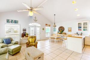 a kitchen and living room with a couch and a table at Take It Sea Z in Gulf Shores
