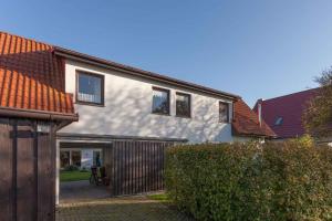 a house with a fence in front of it at Apartment Altenkirchen 4 in Altenkirchen