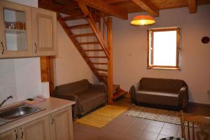 a kitchen with a living room with a stair case at Apartment in Balatonbereny/Balaton 18075 in Balatonberény