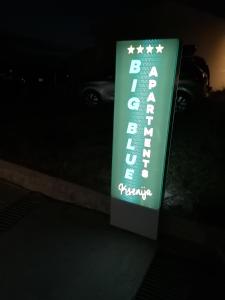 a sign for a parking garage at night at Big Blue - Xenija (Veliko Plavetnilo - Ksenija) in Metajna