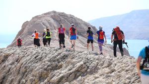 a group of people walking on a rocky mountain at Big Blue - Xenija (Veliko Plavetnilo - Ksenija) in Metajna