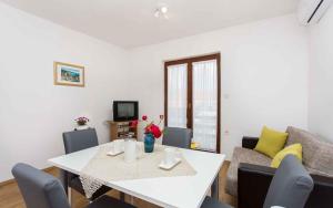 a living room with a white table and a couch at Apartment in Silo/Insel Krk 13496 in Šilo