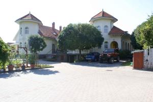 a large house with a car parked in the driveway at Apartment in Siofok/Balaton 19943 in Siófok