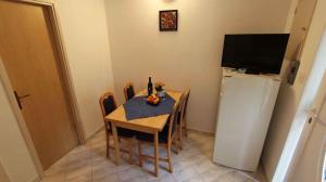 a dining room with a table and a refrigerator at Apartment Porat 22 in Porat