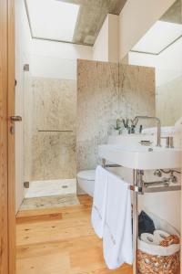 a bathroom with a sink and a shower at Casa do Arco by Douro Exclusive in São Cristóvão do Douro +69 photos