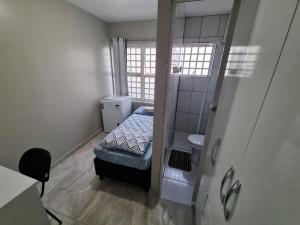 a small bedroom with a bed and a toilet at Morar Bem in Sao Paulo