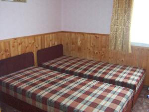 a bedroom with two beds with a plaid bedspread at Holiday home in Szantod - Balaton 20220 in Szántód +22 photos