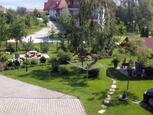 a garden with a park with a statue in the grass at Apartment Balatonszarszo - Balaton 20085 in Balatonszárszó