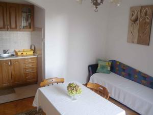 a living room with two tables and a couch at Apartment in Kampor/Insel Rab 16142 in Kampor
