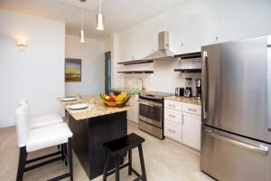 a large kitchen with a stainless steel refrigerator at Bella Luna Beach Condo #227462 in West End