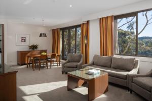 a living room with a couch and a table at Yarra Valley Lodge in Wonga Park
