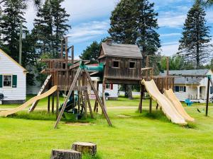 a playground with slides and a play structure at Green Gables Bungalow Court in Cavendish