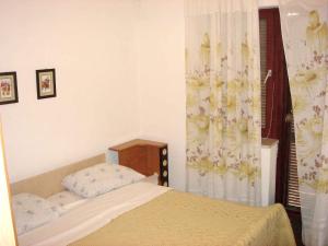 a small bedroom with a bed and a window at Holiday home in Starigrad-Paklenica 6797 in Seline
