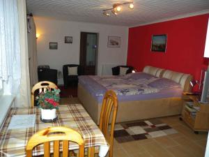 een slaapkamer met een bed en een tafel en stoelen bij Holiday home in Bergen auf Rügen 2852 in Bergen auf Rügen