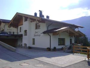 a large white building with a balcony and mountains at Apartment Zell am Ziller 2 in Zell am Ziller +9 photos