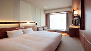 Postel nebo postele na pokoji v ubytování Candeo Hotels Omiya