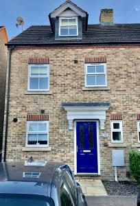 a brick house with a blue door at Delight Marvel-Wexford Place, Maidstone in Maidstone