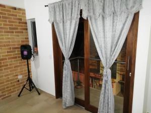 a room with a window with curtains and a camera at Apartamento La Ceja in La Ceja