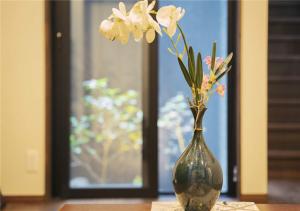 un jarrón con flores en él sentado en una mesa en 谷町君・星屋・城下の宿, en Kioto