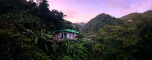 a small house in the middle of a mountain at Casa Grande Mountain Retreat - Adults Only in Utuado