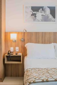 A bed or beds in a room at Flat Completo para uma estadia perfeita NOTA FISCAL