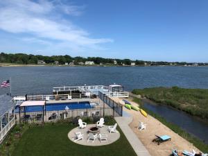 a boat on the water with chairs and tables at Bayview Resort in Hampton Bays
